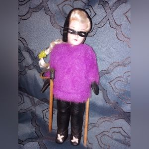 Vintage ski costume doll. Female in black leather ski mask and suit with wooden